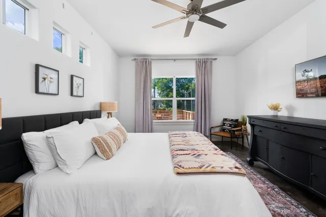 a bedroom with a bed and a window