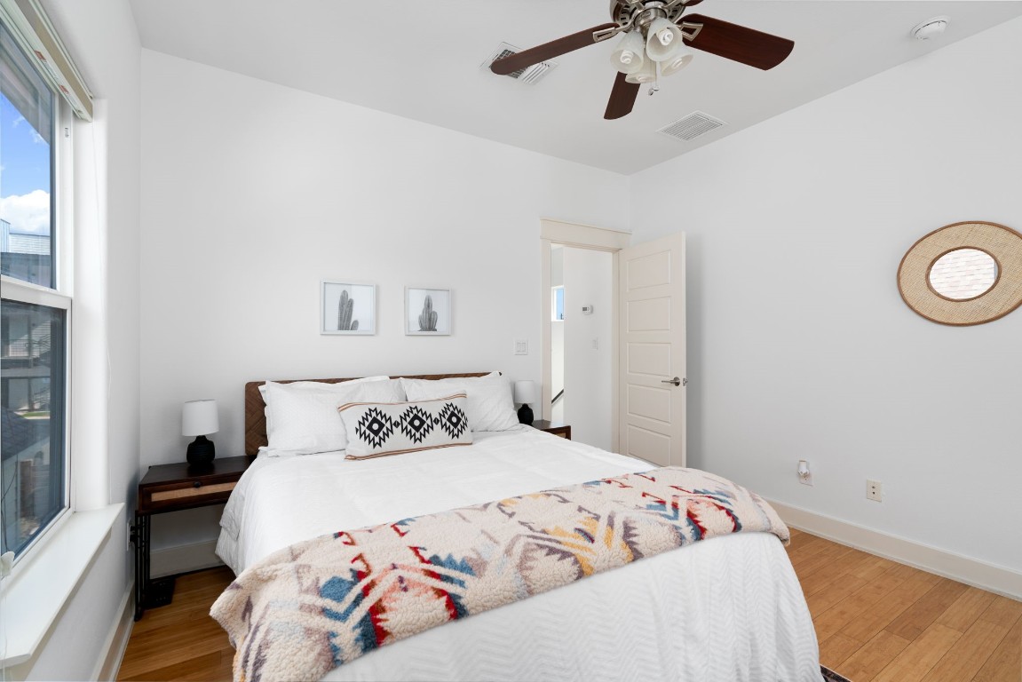 3012 Neal Street Austin, TX 78702 - Photo 26 of 39 a bedroom with a bed and a chandelier