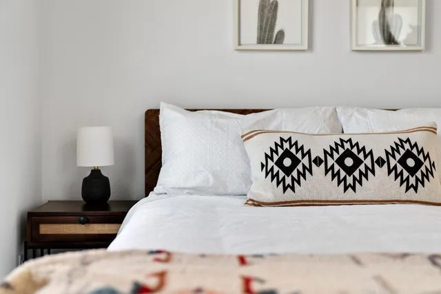 a bedroom with a bed and a painting on the wall