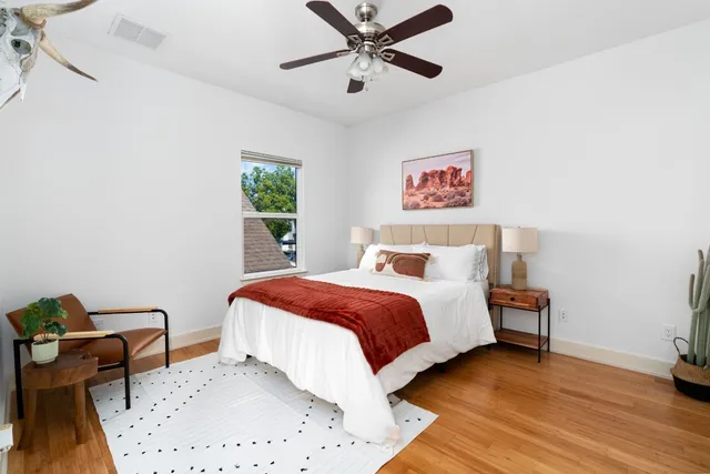 a bedroom with a bed and a chair