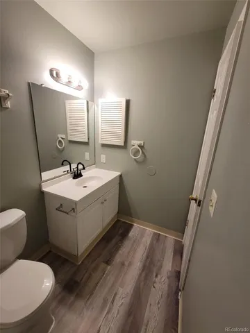 a bathroom with a sink mirror and toilet