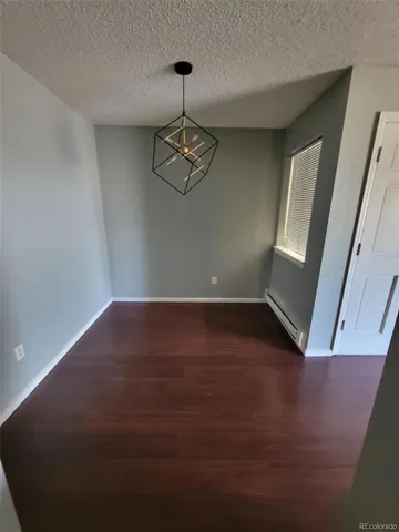 a view of room with window and hardwood floor