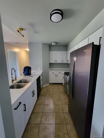 a kitchen with stainless steel appliances a refrigerator sink and cabinets