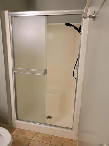 a bathroom with a glass shower door