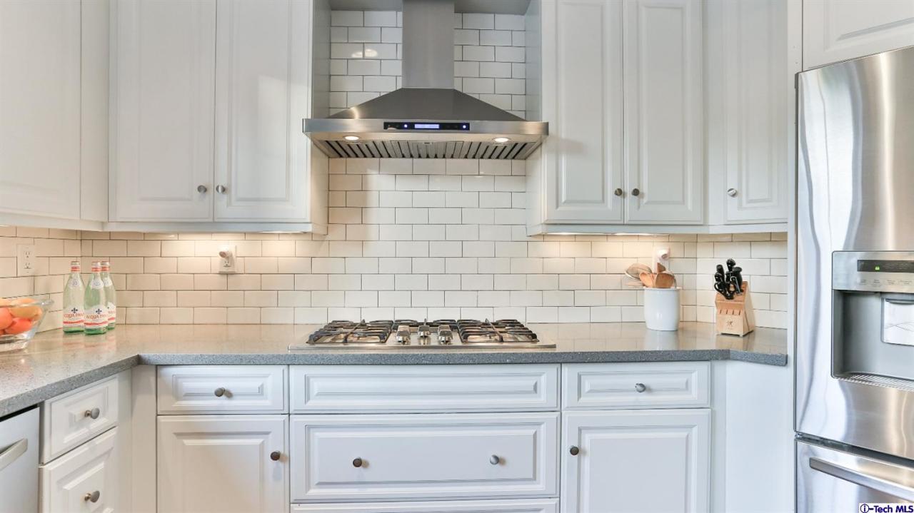 3561 Giddings Ranch Road Altadena, CA 91001 - Photo 14 of 60 a kitchen with granite countertop white cabinets and white appliances