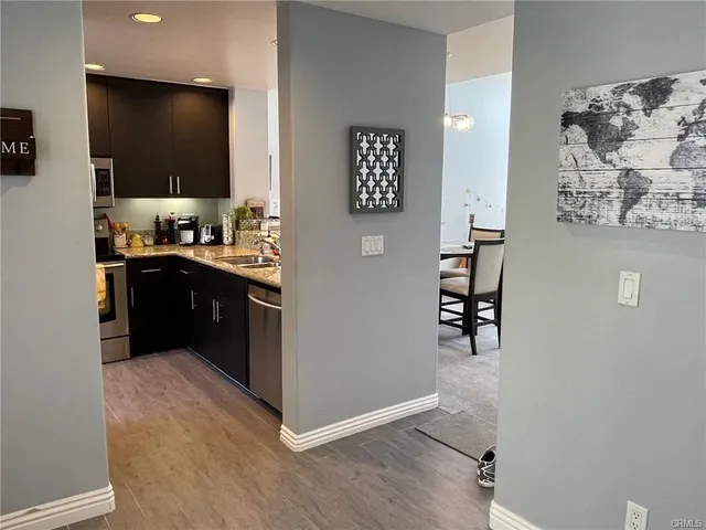 a kitchen with a sink and steel appliances