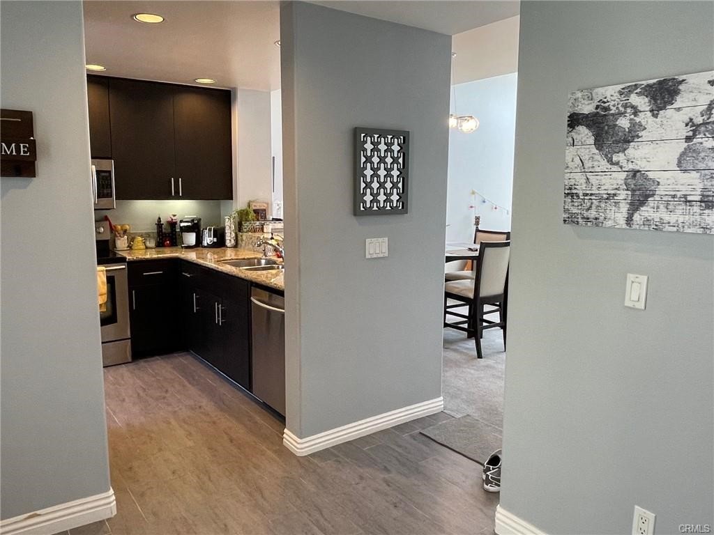 2233 Martin, Unit 413 Irvine, CA 92612 - Photo 14 of 38 a kitchen with stainless steel appliances granite countertop a refrigerator and a sink