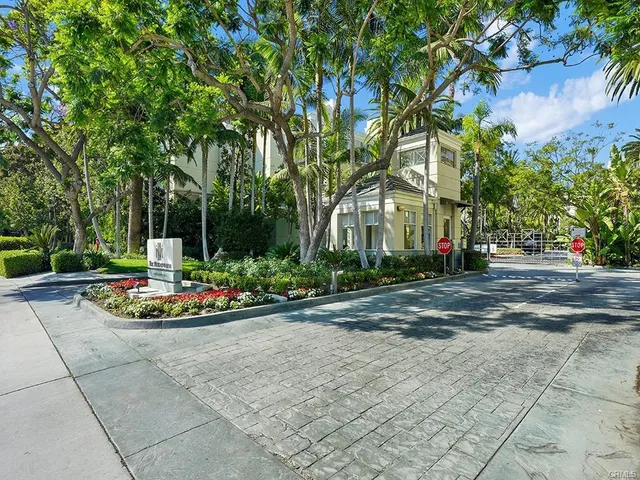 a front view of a house with a garden and trees