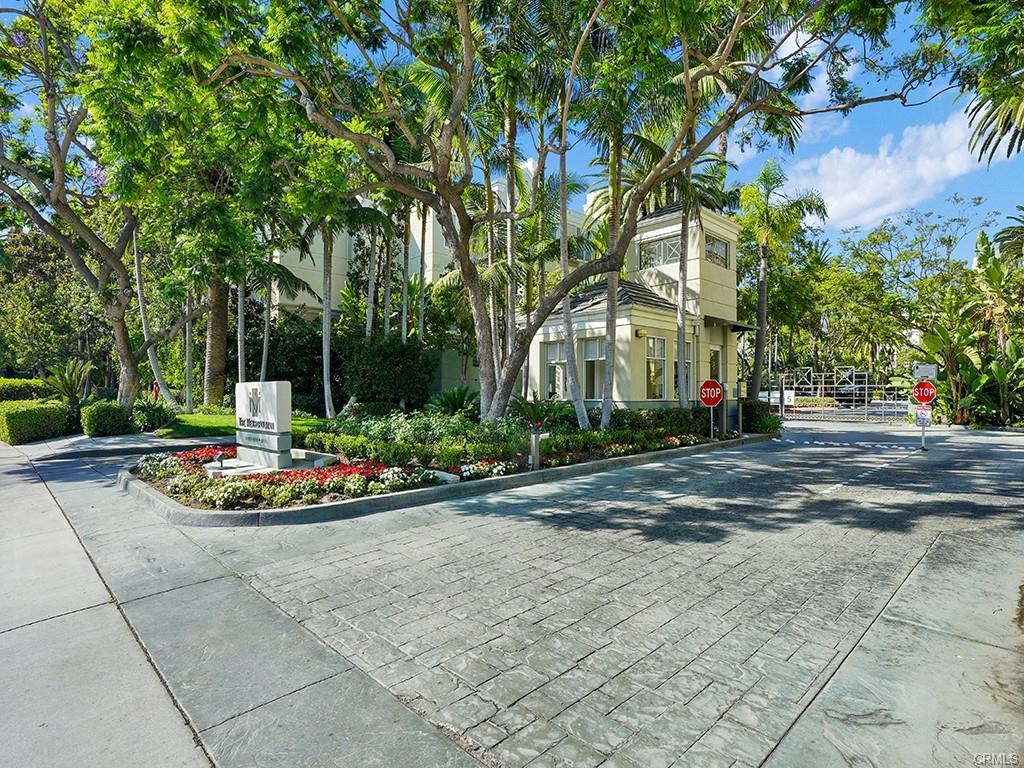 2233 Martin, Unit 413 Irvine, CA 92612 - Photo 2 of 38 a front view of a house with a garden and trees