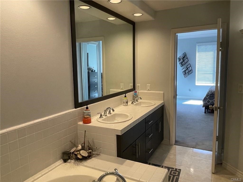 2233 Martin, Unit 413 Irvine, CA 92612 - Photo 30 of 38 a bathroom with a sink and a mirror