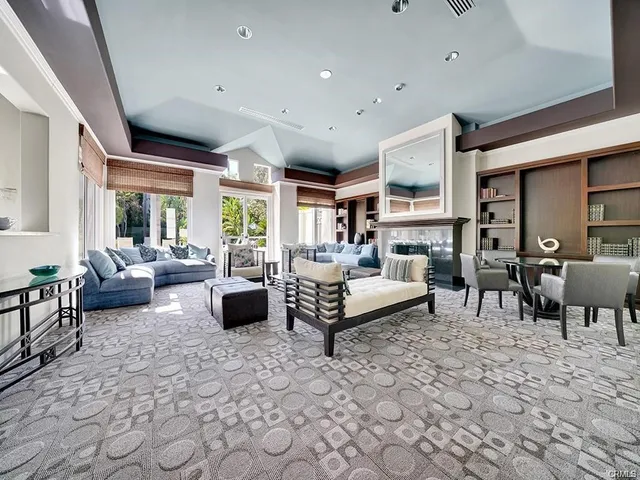 a living room with furniture a large window and chairs