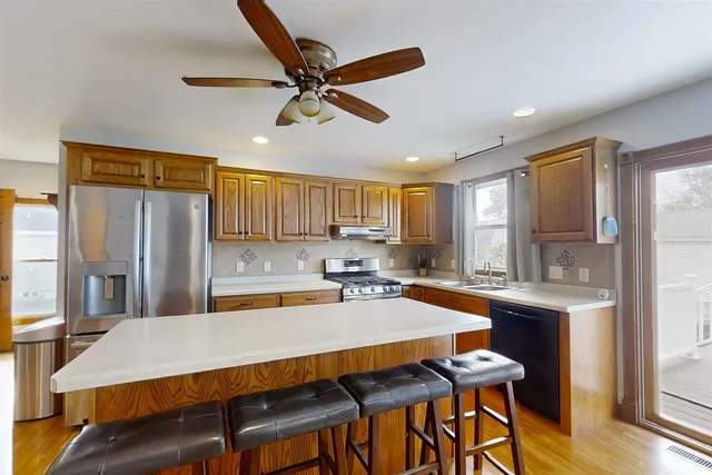 a kitchen with a table chairs refrigerator and cabinets