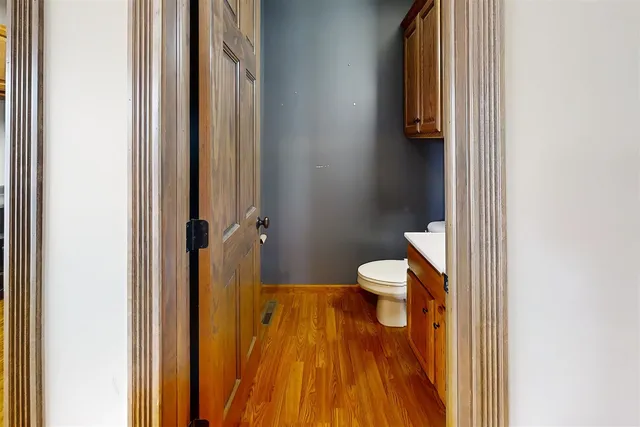 a bathroom with a toilet and a mirror
