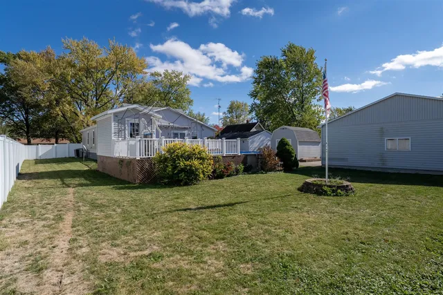 a view of a balcony with wooden floor and fence