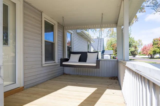 a balcony view with a couch and wooden floor