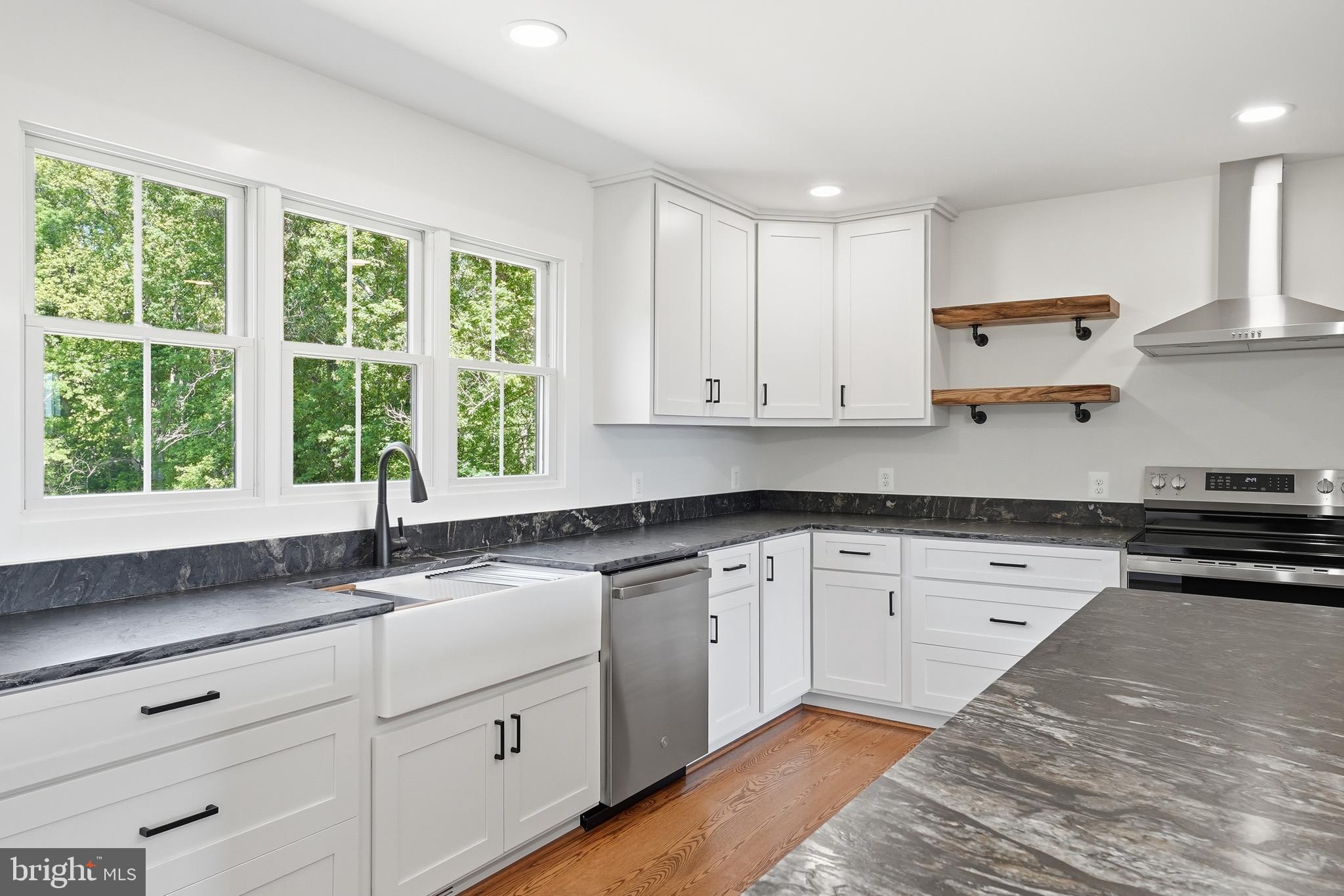 1548 James City Road Reva, VA 22735 - Photo 18 of 48 a kitchen with granite countertop white cabinets white appliances a sink and a large window