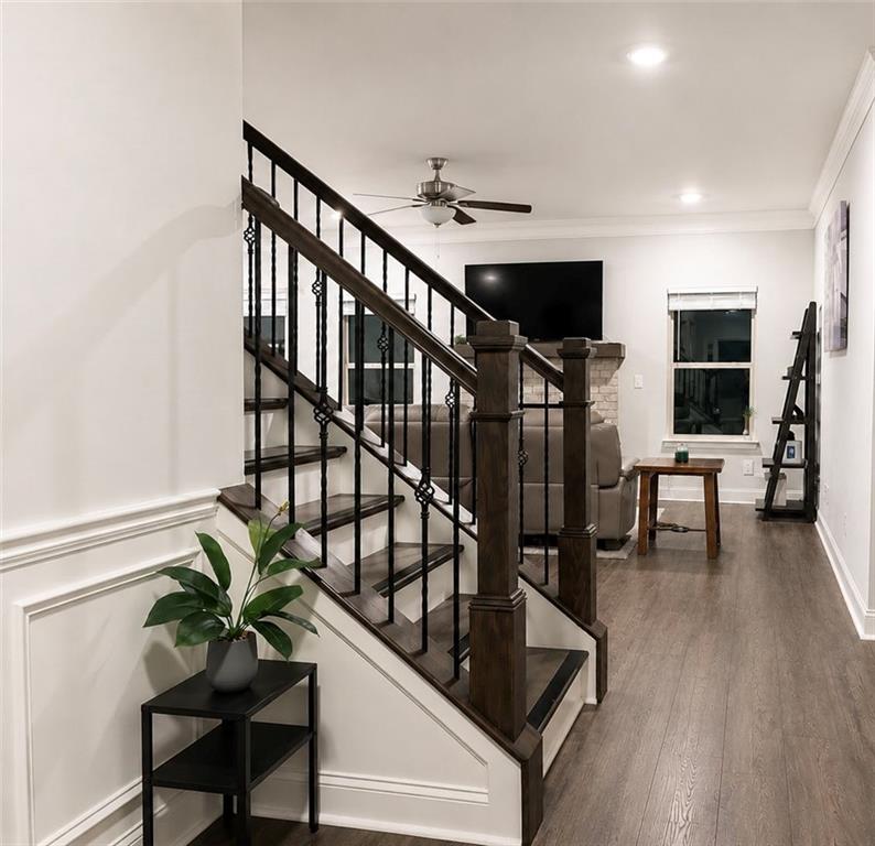 3359 Elkhorn Ridge Run Dacula, GA 30019 - Photo 4 of 35 a view of staircase with furniture and wooden floor