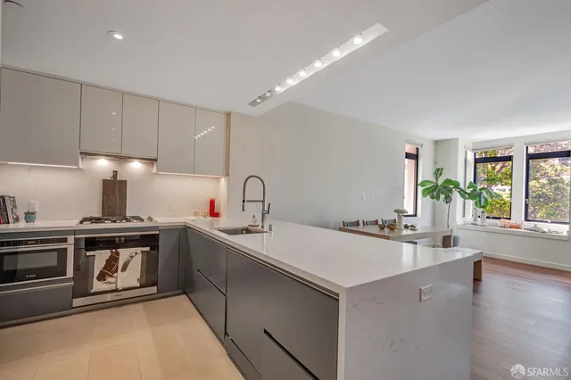 a kitchen with a sink a stove and cabinets