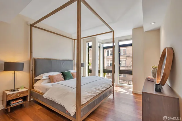a bedroom with a bed window and a flat screen tv