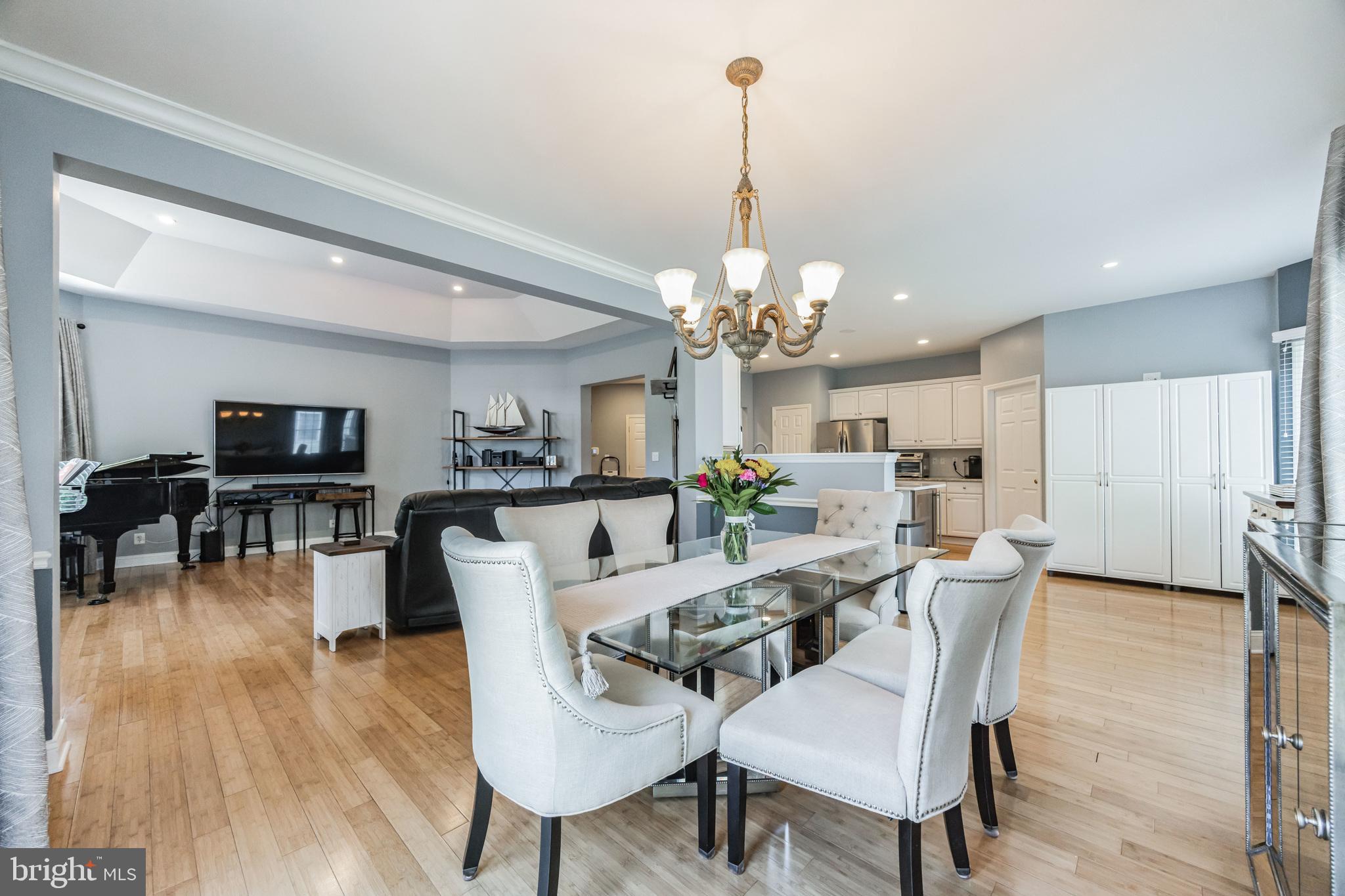 8 Kelso Lane Cinnaminson, NJ 08077 - Photo 12 of 38 a view of a dining room and livingroom with furniture wooden floor a chandelier