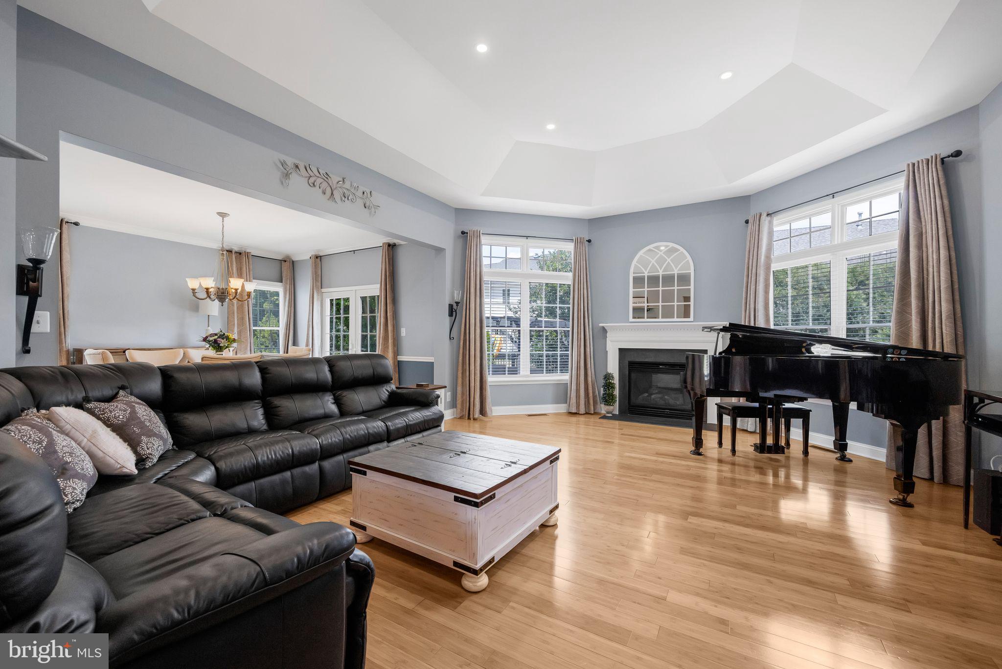 8 Kelso Lane Cinnaminson, NJ 08077 - Photo 15 of 38 a living room with furniture a fireplace a dining table and large windows
