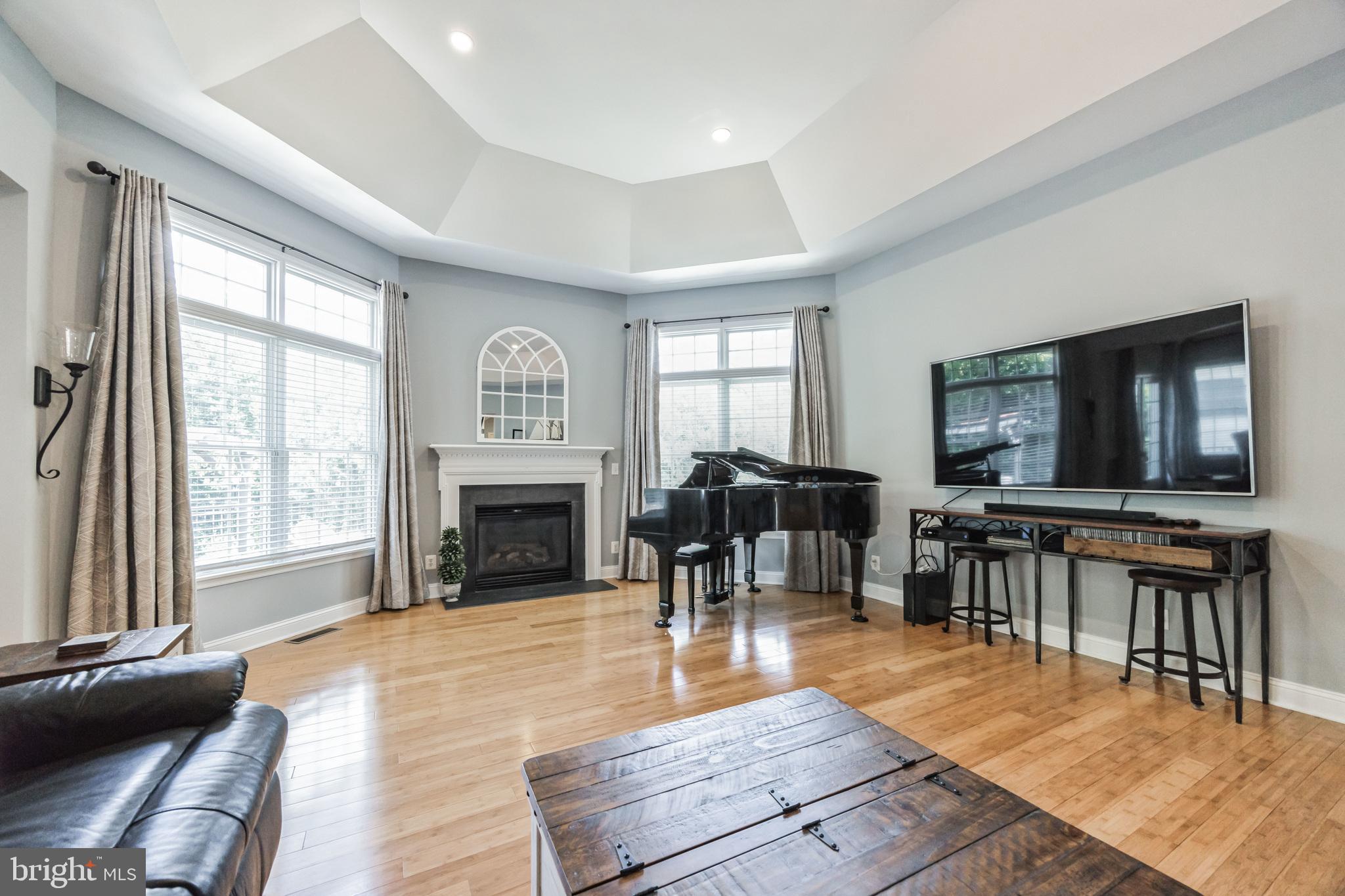 8 Kelso Lane Cinnaminson, NJ 08077 - Photo 16 of 38 a living room with furniture a fireplace and a flat screen tv