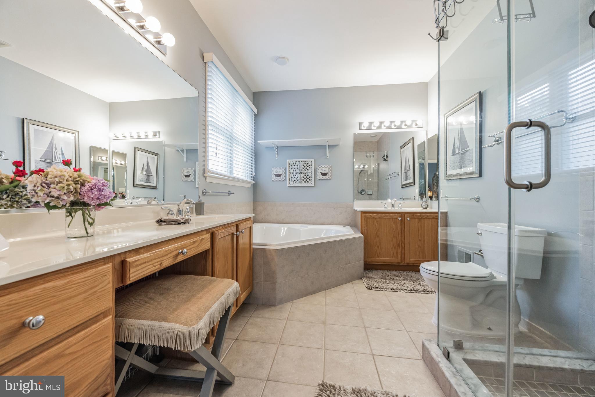 8 Kelso Lane Cinnaminson, NJ 08077 - Photo 21 of 38 a large bathroom with a sink a toilet a mirror and bathtub