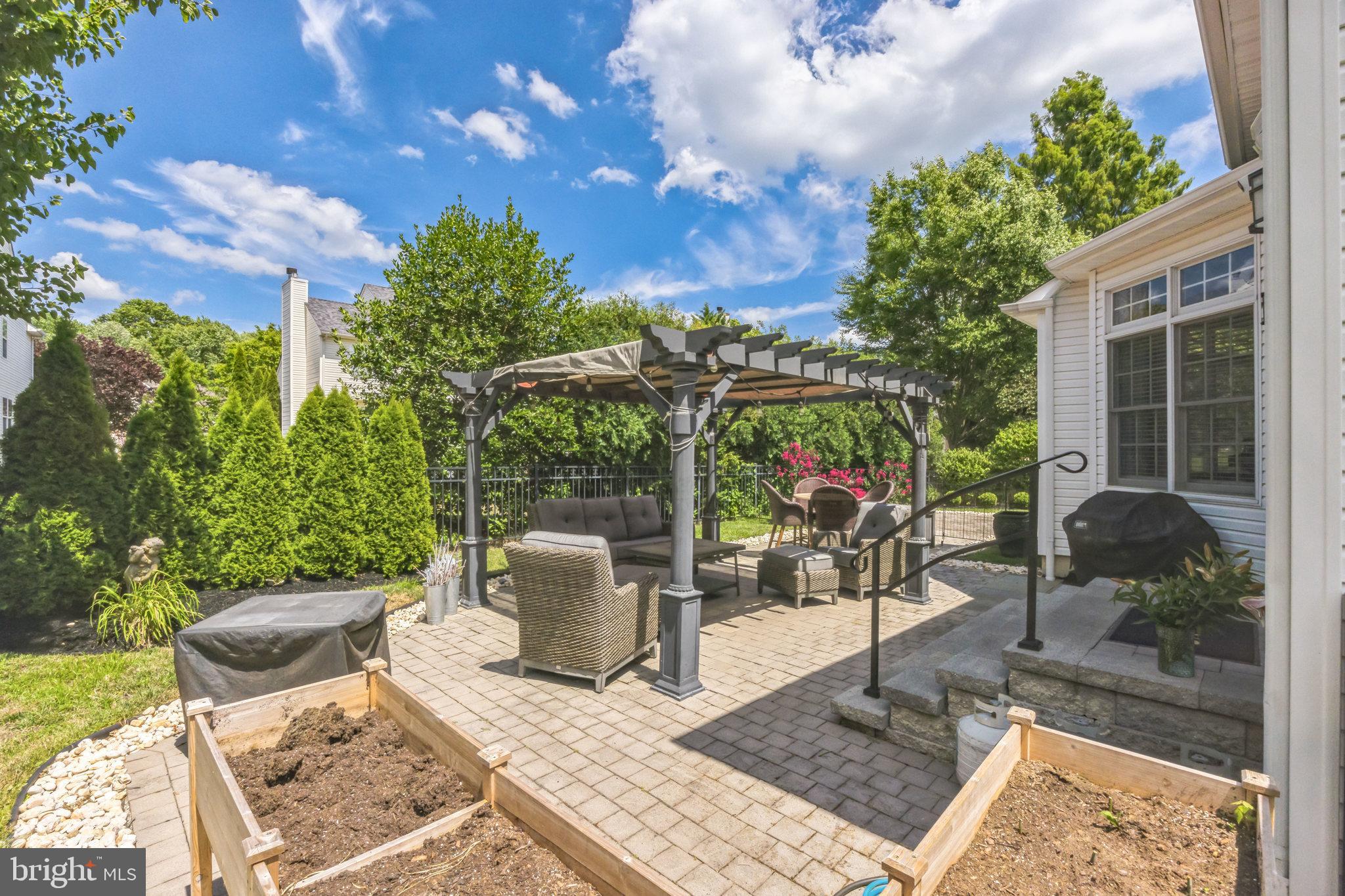 8 Kelso Lane Cinnaminson, NJ 08077 - Photo 29 of 38 a view of a patio with table and chairs potted plants and floor to ceiling window and potted plants