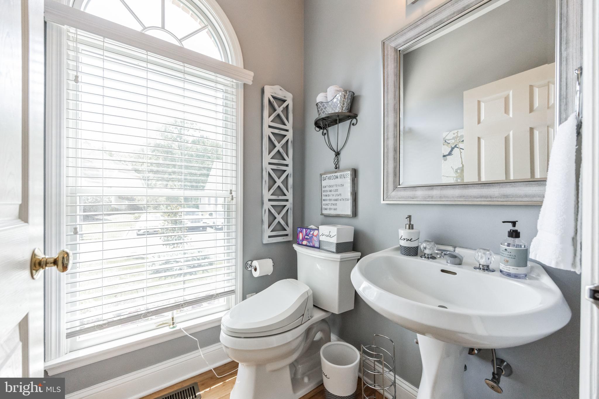 8 Kelso Lane Cinnaminson, NJ 08077 - Photo 8 of 38 a bathroom with a sink a toilet and a mirror