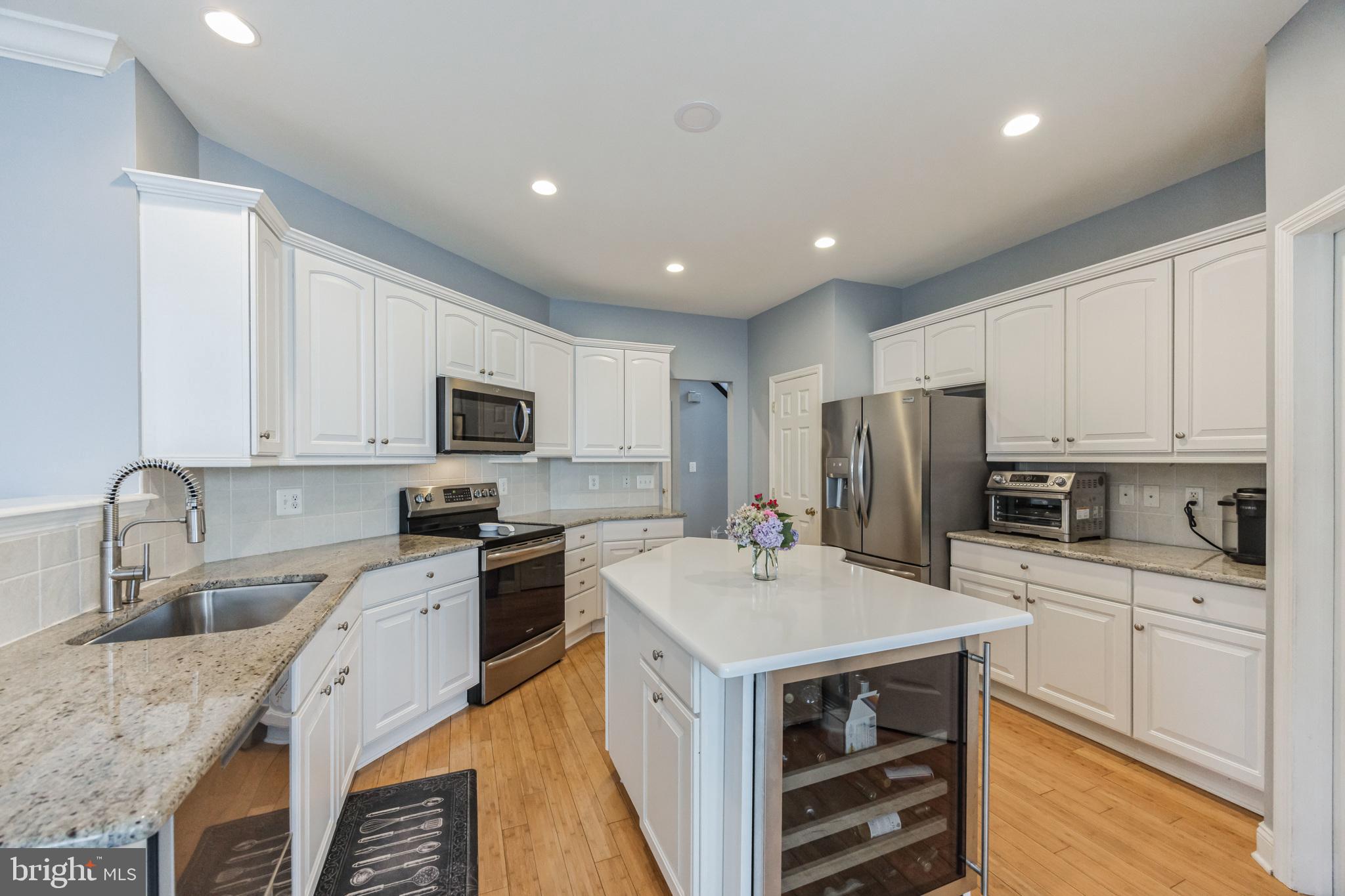 8 Kelso Lane Cinnaminson, NJ 08077 - Photo 9 of 38 a kitchen with a sink a counter top space stainless steel appliances and cabinets