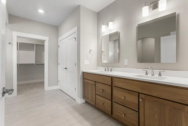 a spacious bathroom with a double vanity sink mirror and double