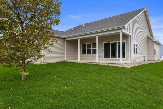 a view of a house with a backyard