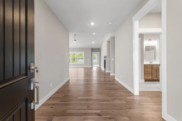 a view of hallway with wooden floor