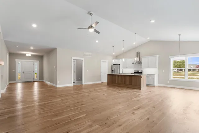 a view of kitchen with kitchen island and stainless steel appliances