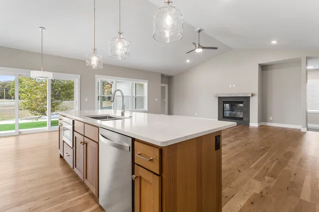 a kitchen with a stove and a wooden floor