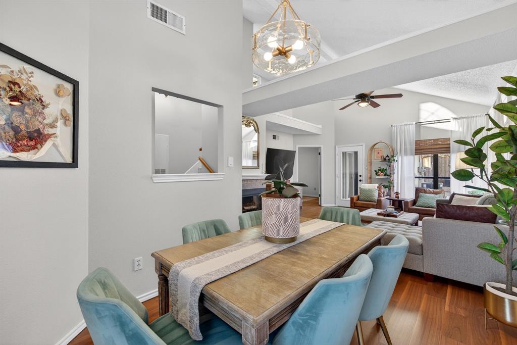 2941 Hunters Point Lane Carrollton, TX 75007 - Photo 13 of 40 a view of a dining room with furniture a chandelier and wooden floor