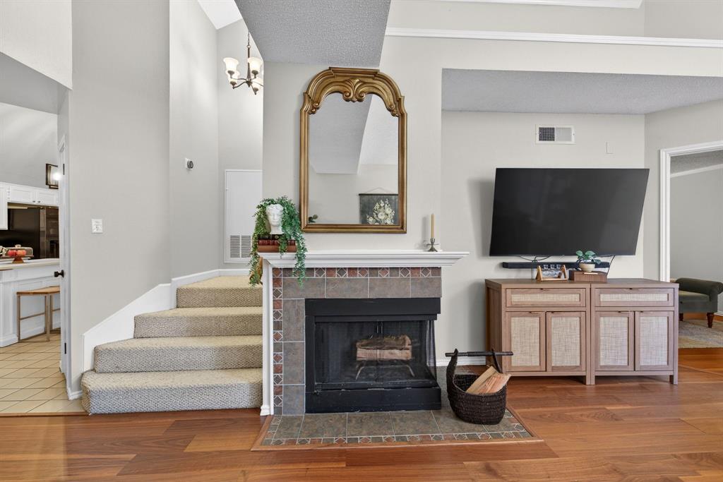 2941 Hunters Point Lane Carrollton, TX 75007 - Photo 14 of 40 a living room with fireplace furniture and a flat screen tv