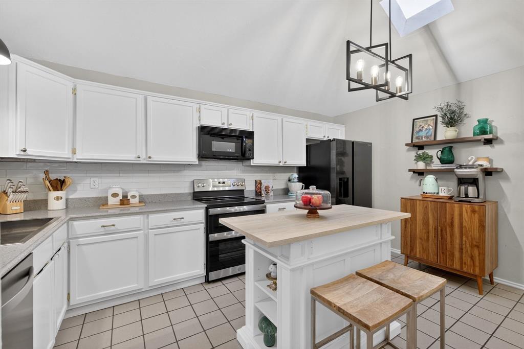 2941 Hunters Point Lane Carrollton, TX 75007 - Photo 15 of 40 a kitchen with a sink cabinets and window