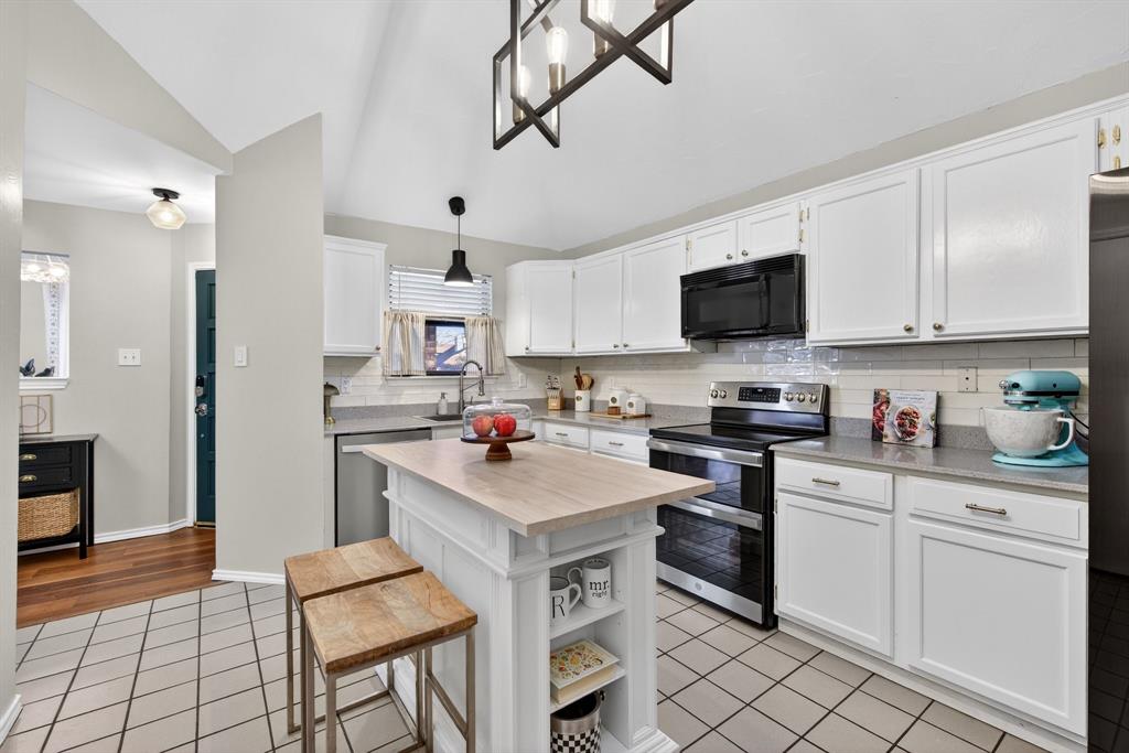2941 Hunters Point Lane Carrollton, TX 75007 - Photo 16 of 40 a kitchen with white cabinets and appliances