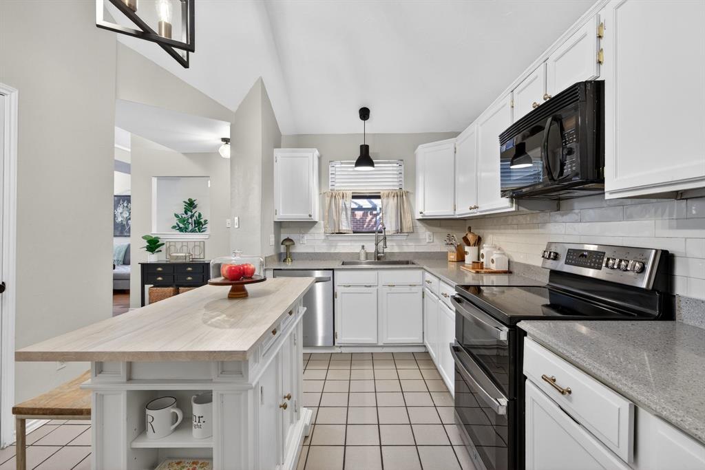 2941 Hunters Point Lane Carrollton, TX 75007 - Photo 17 of 40 a kitchen with a sink a stove and cabinets