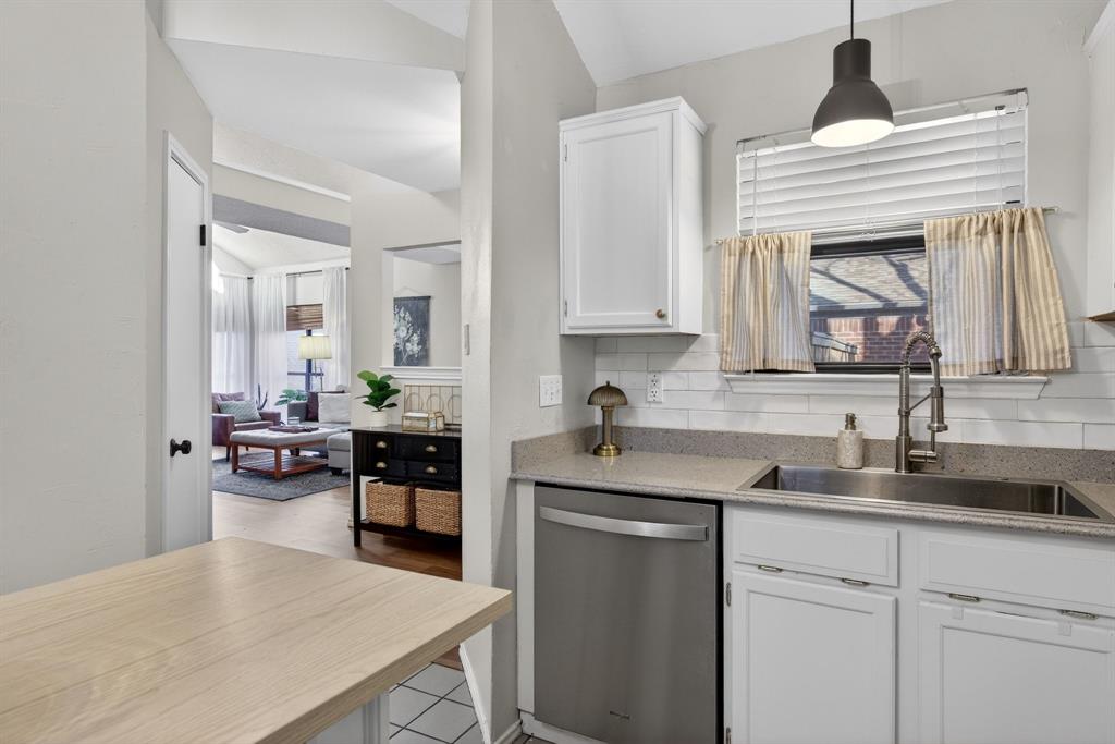 2941 Hunters Point Lane Carrollton, TX 75007 - Photo 18 of 40 a kitchen with stainless steel appliances granite countertop a sink and cabinets