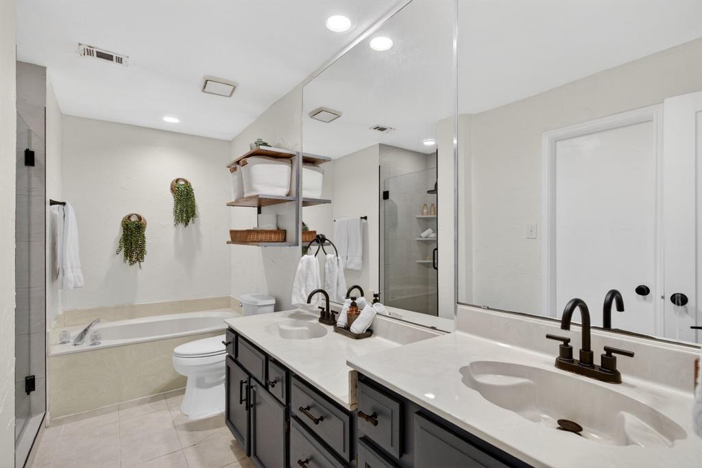 2941 Hunters Point Lane Carrollton, TX 75007 - Photo 22 of 40 a bathroom with a sink double vanity granite toilet tub and shower