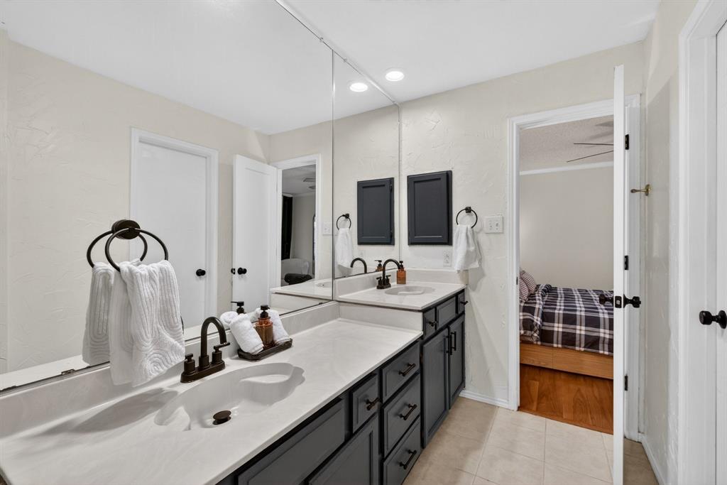2941 Hunters Point Lane Carrollton, TX 75007 - Photo 24 of 40 a bathroom with a double vanity sink and a mirror