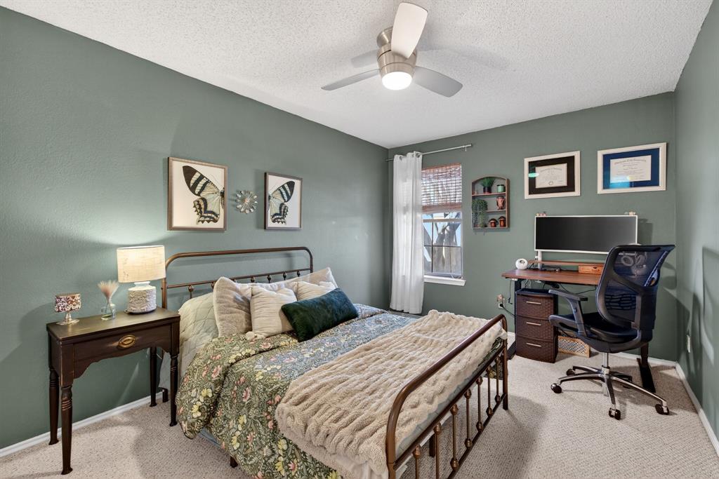 2941 Hunters Point Lane Carrollton, TX 75007 - Photo 25 of 40 a bedroom with a bed and a desk