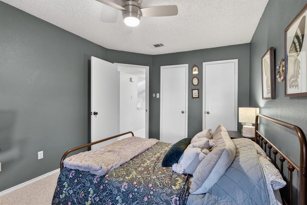 2941 Hunters Point Lane Carrollton, TX 75007 - Photo 26 of 40 a bedroom with a bed and a chandelier