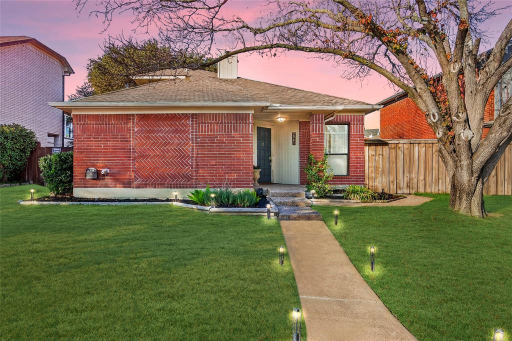 2941 Hunters Point Lane Carrollton, TX 75007 - Photo 2 of 40 a front view of a house with a garden and yard