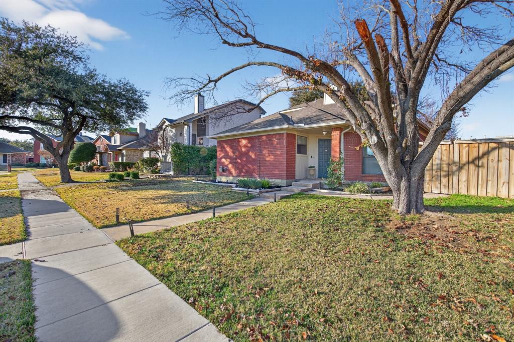 2941 Hunters Point Lane Carrollton, TX 75007 - Photo 35 of 40 a view of a building with a yard
