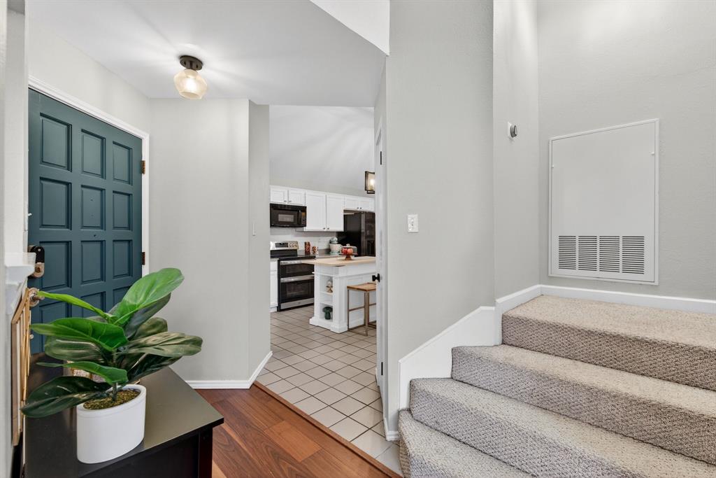 2941 Hunters Point Lane Carrollton, TX 75007 - Photo 6 of 40 a living room with furniture potted plant and kitchen view