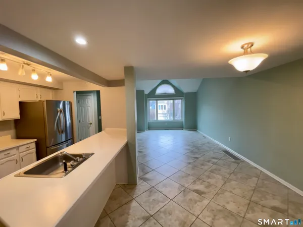 a kitchen with stainless steel appliances granite countertop a sink and a refrigerator