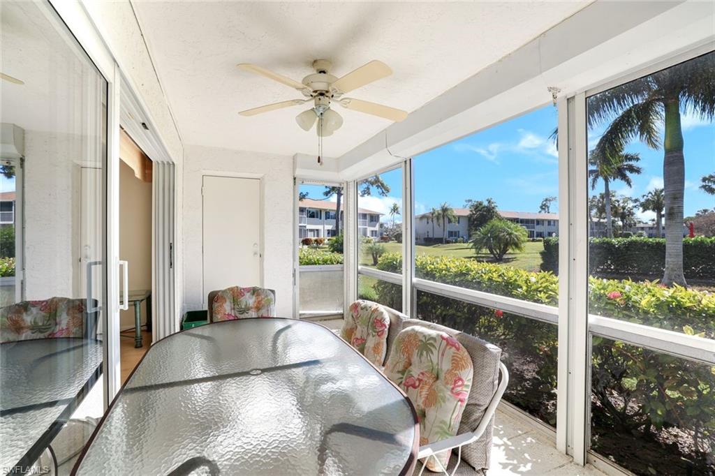 247 Winners Circle, Unit 5 Naples, FL 34112 - Photo 15 of 24 Sunroom / solarium with outdoor dining space and ceiling fan